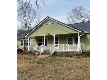 Charming single-story home featuring a quaint front porch and inviting curb appeal at 610 W Old Rd, Lillington, NC 27546