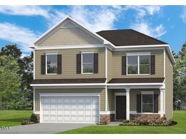 Two-story home with a neutral color scheme, a two-car garage, and classic shutters for a welcoming curb appeal at 4867 Pioneer Dr, Sanford, NC 27330