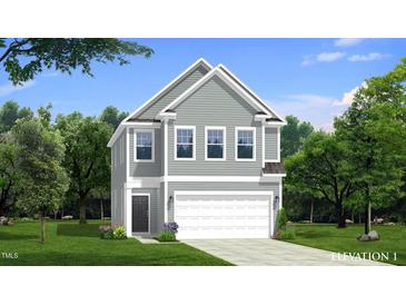 Charming two-story home featuring gray siding, a two-car garage, and a well-manicured lawn at 1107 Shovelhead Dr # Homesite 39, Durham, NC 27703