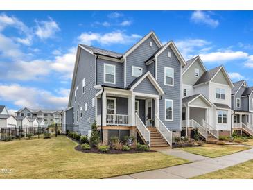 Charming two-story home featuring a welcoming front porch and well-maintained landscaping at 1136 Remey Ave, Wake Forest, NC 27587
