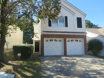 Charming two-story home with a two-car garage and brick accents on the front at 1613 Beacon Valley Dr, Raleigh, NC 27604