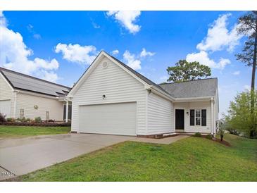 Charming one-story home featuring white siding, a spacious garage, and a well-manicured lawn at 2120 Castle Pines Dr, Raleigh, NC 27604