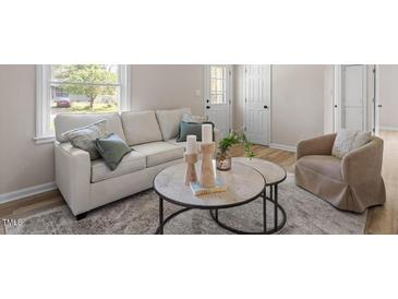 Cozy living room features a comfortable sofa, area rug, and stylish decor at 2304 Nelson St, Raleigh, NC 27610