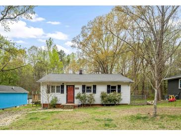 Charming single-story home with a red front door and a well-maintained front yard at 2721 Thelma St, Durham, NC 27704