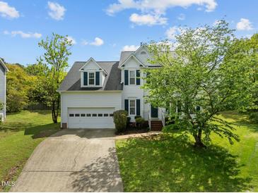 Charming two-story home featuring a two-car garage and a beautifully landscaped front yard with mature trees at 113 Laurel Branch Dr, Cary, NC 27513