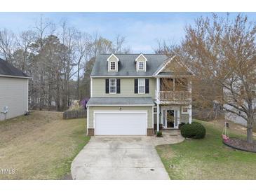 Charming two-story home with a two-car garage and a balcony on the front at 416 Collinsworth Dr, Clayton, NC 27527