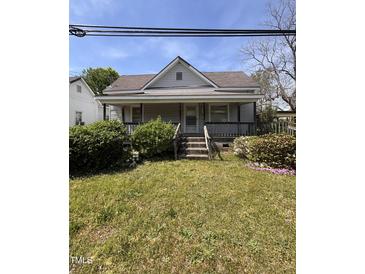 Charming home with mature shrubs, front porch and classic details at 609 N Magnolia Ave, Dunn, NC 28334