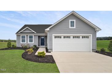 Charming one-story home with gray siding, a two-car garage, and a beautifully landscaped front yard at 66 Furley St, Sanford, NC 27330