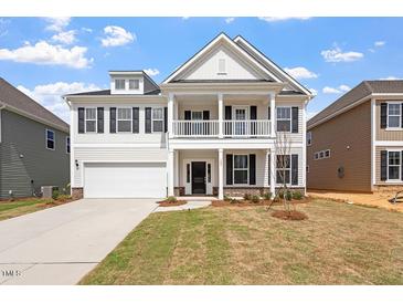 Charming two-story home features a welcoming front porch and a two-car garage at 104 Black Walnut Dr # 202, Garner, NC 27529
