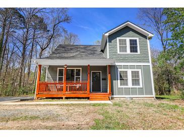 Charming home featuring a welcoming front porch with sturdy columns and new paint at 218 Archdale Dr, Durham, NC 27707