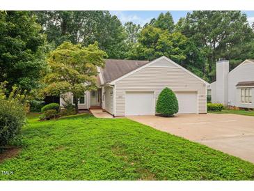 Charming home with a two-car garage, a well-maintained lawn, and mature landscaping at 227 Chimney Rise Dr, Cary, NC 27511