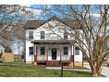 Charming two-story home with a welcoming front porch and beautifully landscaped front yard at 2517 Newbold St, Raleigh, NC 27603