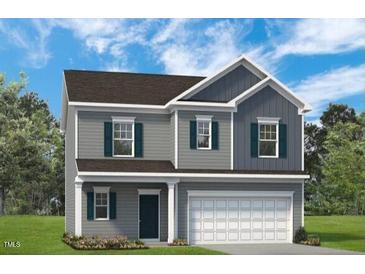 Two story home with blue accent shutters, and a gray garage door at 306 Deodora Ln, Cameron, NC 28326