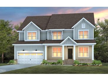 Charming two-story home showcasing a modern design, garage, and well-manicured landscaping at 63 W Silver Bridle Trl, Wendell, NC 27591