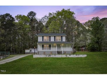 Inviting two-story home with a charming front porch and lush green lawn at 124 Maluli Dr, Oxford, NC 27565