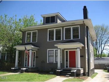 Charming gray duplex with red doors, white trim, and a small front lawn under a clear, blue sky at 1308 Wake Forest Rd, Raleigh, NC 27604