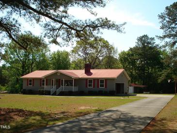 Charming home with a red roof, red shutters, and a well-manicured lawn at 136 Scramble Rd, Erwin, NC 28339
