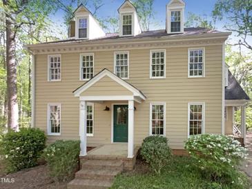 Charming two-story home features a green front door, dormer windows, and mature landscaping at 145 Brannigan Pl, Cary, NC 27511