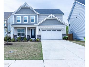 Charming two-story home with a two-car garage and manicured front lawn at 1950 Menet St, Apex, NC 27502
