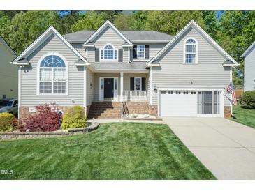 Charming two-story home with well-manicured lawn and attached two-car garage at 212 Mickleson Ridge Dr, Raleigh, NC 27603