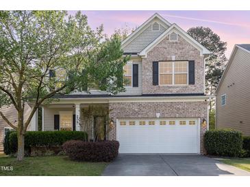Charming two-story home featuring a brick facade, attached two-car garage, and well-manicured landscaping at 2317 Rainy Lake St, Wake Forest, NC 27587