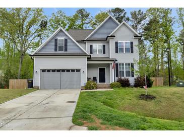 Charming two-story home with gray siding, manicured lawn, and a two-car garage at 375 Alcock Ln, Youngsville, NC 27596