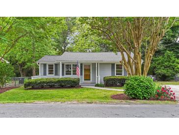 Charming single-story home with gray siding, mature trees, manicured lawn, and welcoming front porch at 423 N Main St, Wendell, NC 27591