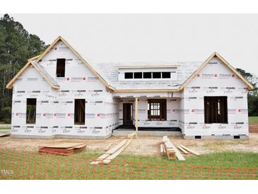 Exterior construction of a new home with protective wrap, showcasing the framing and initial stages of building at 4330 Medicus Ln, Franklinton, NC 27525