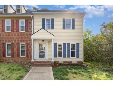 Charming two-story home featuring blue shutters, cream siding, and a welcoming front entrance at 5013 Dunwoody Trl, Raleigh, NC 27606