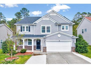 Charming two-story home with gray siding, a well-manicured lawn, and attached two car garage at 619 Ashburn Ln, Durham, NC 27703