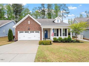 Charming single-story brick home featuring a well-manicured lawn and attached garage at 713 Catherine Lake Ct, Fuquay Varina, NC 27526