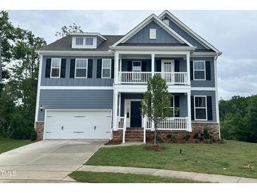 Charming two-story home featuring a welcoming porch and a well-manicured lawn at 103 Berry Mill Ln # 133, Raleigh, NC 27603