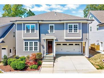 Charming two-story home with a two-car garage, landscaped yard, and beautiful architectural details at 1309 Pecora Ln, Raleigh, NC 27607