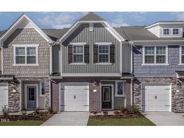 Charming two-story townhome with gray siding, brick accents, and a one-car garage at 2122 Willow Gln Dr, Graham, NC 27253