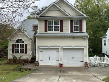 Charming two-story home with a two-car garage, red shutters, and a well-maintained front yard at 2305 Summit Dr, Hillsborough, NC 27278