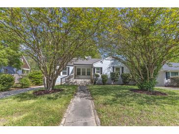 Charming home with a walkway leading to the front porch and beautiful trees providing shade at 2522 N Roxboro St, Durham, NC 27704