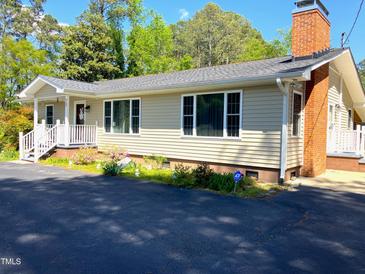Charming one-story home featuring a brick chimney, inviting front porch and well-manicured landscaping at 4159 Princeton Kenly Road, Kenly, NC 27542