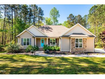 Charming single-story home featuring a bright turquoise door and a welcoming front porch at 4290 Sustain Cir, Franklinton, NC 27525