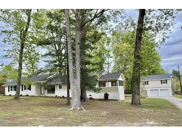 Charming single-story home featuring a covered porch, neutral paint, and mature trees at 508 & 510 Gordon St, Roxboro, NC 27573