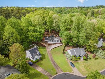 An aerial view of a white single-Gathering home nestled among lush green trees at 508 Baygall Rd, Holly Springs, NC 27540