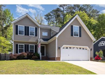 Charming two-story home featuring a two-car garage, manicured lawn, and traditional vinyl siding at 5413 Botany Bay Dr, Raleigh, NC 27616