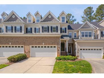 Charming townhome showcasing brick facade, dormer windows, and attached garages at 109 Jones Creek Pl, Chapel Hill, NC 27516