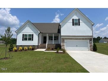 Charming white two-story home with well-manicured lawn and inviting curb appeal at 11430 International Dr, Middlesex, NC 27557