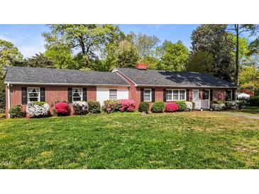 Charming one-story brick home with black shutters and colorful azaleas in the front yard at 118 Shannon Dr, Burlington, NC 27215
