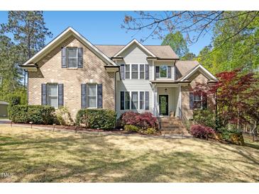 Beautiful brick and siding two-story home with manicured landscaping and inviting front entrance at 1503 Anterra Dr, Wake Forest, NC 27587