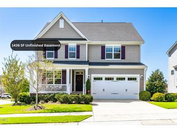 Charming two-story home with a manicured front yard, complemented by a two-car garage and inviting front porch at 240 Liberty Star Rd, Wendell, NC 27591
