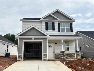 Charming new construction home with two stories, a two car garage, and stone accents on the columns at 244 Bluejay St, Clayton, NC 27520