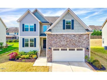 Charming two-story home with stone accents, a two-car garage, and a well-manicured front yard at 3338 Prospect Parkway Pkwy, Durham, NC 27703
