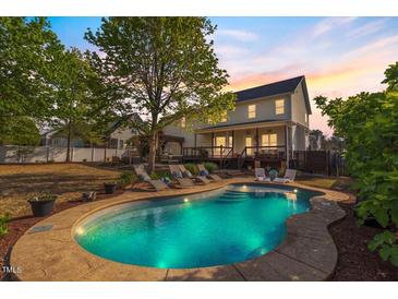 Inviting backyard pool with lounge chairs and deck area, perfect for outdoor relaxation and entertaining at 387 Windgate Dr, Clayton, NC 27527