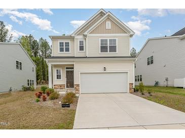 Charming two-story home with a two-car garage, well-maintained lawn, and inviting curb appeal at 4005 Sierra Pelona Dr, Raleigh, NC 27616